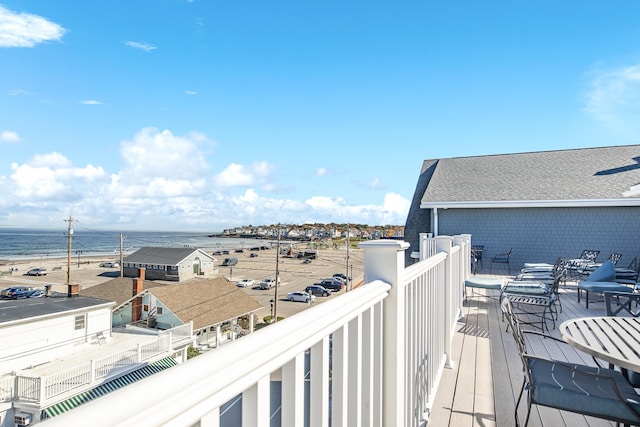 wooden terrace featuring a water view