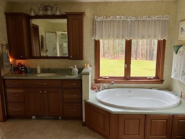 bathroom with vanity, tile patterned flooring, a garden tub, and a stall shower