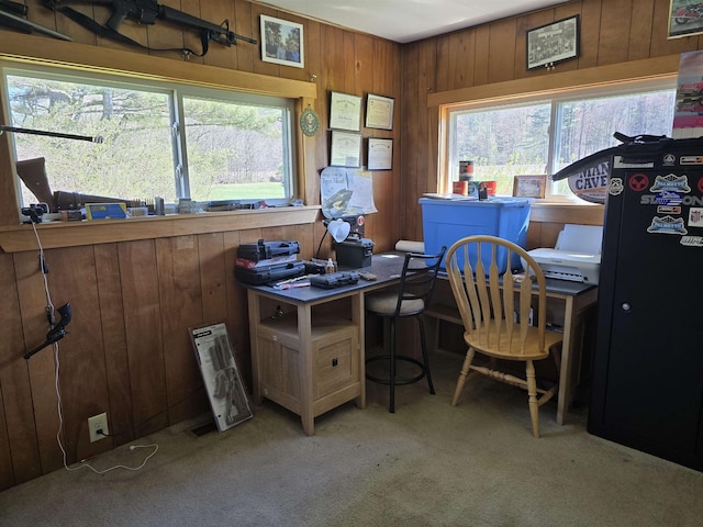 home office with carpet floors and wood walls
