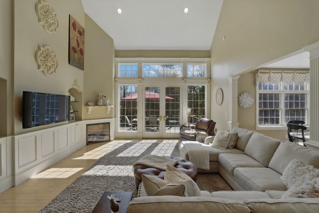 7 Champagne Ter, Bedford, NH 03110 - living area with ornate columns, wood finished floors, a healthy amount of sunlight, and high vaulted ceiling