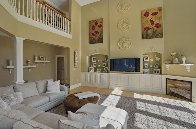 7 Champagne Ter, Bedford, NH 03110 - living room with light wood-style floors, decorative columns, built in shelves, and a towering ceiling
