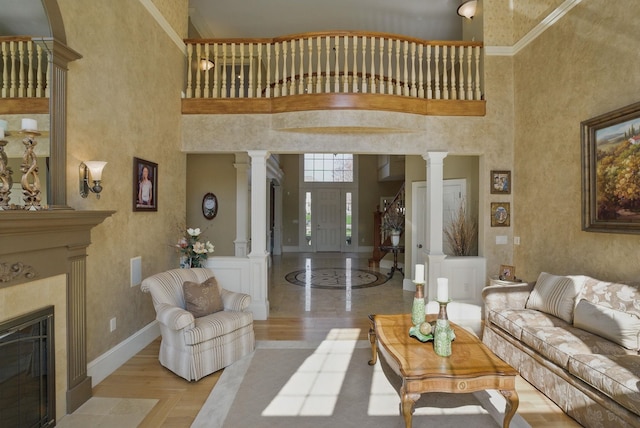 7 Champagne Ter, Bedford, NH 03110 - living room with a high ceiling, a fireplace, baseboards, decorative columns, and ornamental molding