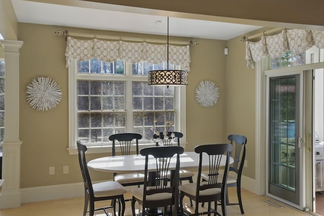 7 Champagne Ter, Bedford, NH 03110 - dining space featuring baseboards, light wood-style flooring, and decorative columns