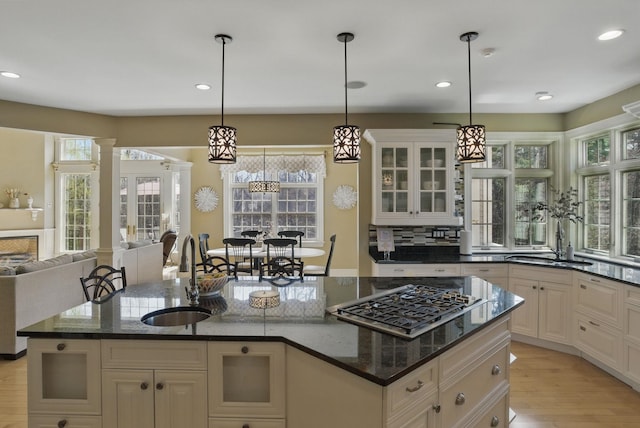 7 Champagne Ter, Bedford, NH 03110 - kitchen with a sink, glass insert cabinets, stainless steel gas stovetop, and open floor plan