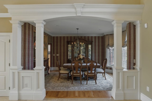 7 Champagne Ter, Bedford, NH 03110 - dining room featuring arched walkways, wallpapered walls, and wood finished floors