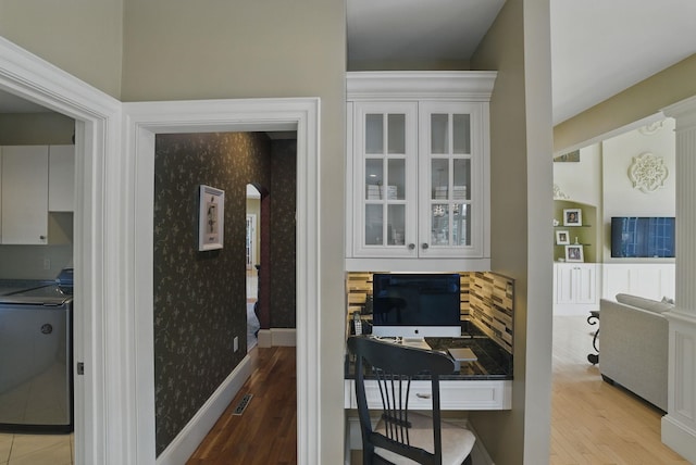 7 Champagne Ter, Bedford, NH 03110 - hallway with washer / dryer, baseboards, and light wood finished floors