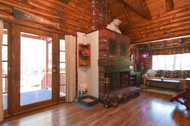 living room featuring a fireplace, high vaulted ceiling, beamed ceiling, and wood finished floors