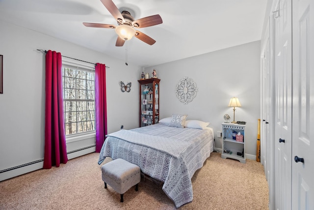 carpeted bedroom featuring ceiling fan, baseboard heating, and a closet