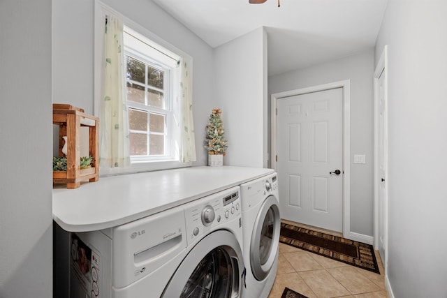 washroom with baseboards, laundry area, light tile patterned flooring, and washer and dryer