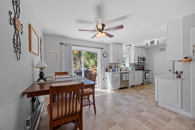 dining area with a baseboard radiator and a ceiling fan