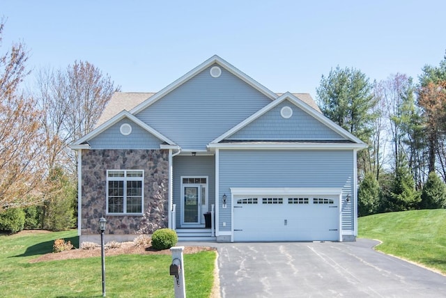 view of front facade featuring stone siding, an attached garage, a front yard, and aphalt driveway