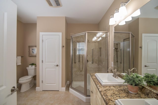 bathroom featuring visible vents, a stall shower, a sink, tile patterned floors, and toilet