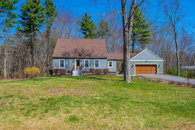 cape cod home featuring a garage, driveway, and a front lawn