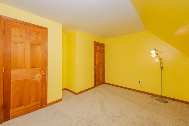 bonus room featuring carpet floors, baseboards, and lofted ceiling