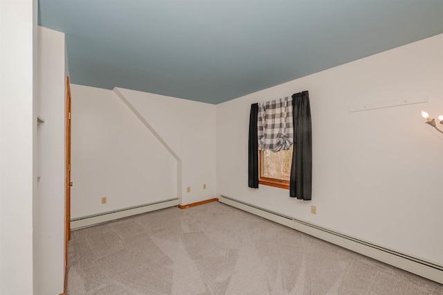 empty room with carpet floors, baseboards, and baseboard heating