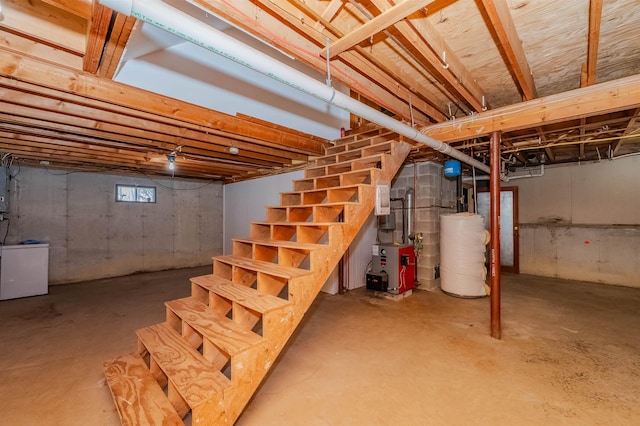 below grade area with electric panel, gas water heater, stairs, and a heating unit
