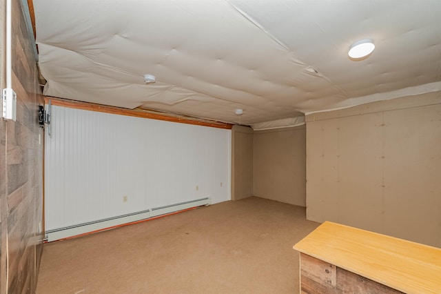 finished basement with carpet floors and a baseboard radiator