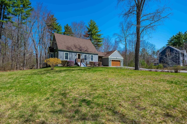 view of front of house featuring an attached garage and a front lawn