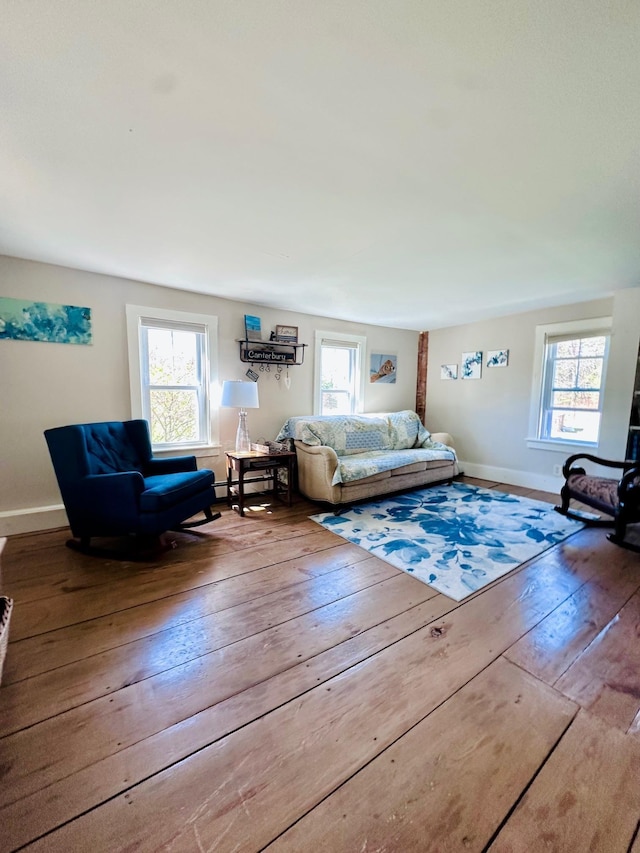 living room with baseboards, baseboard heating, and hardwood / wood-style flooring