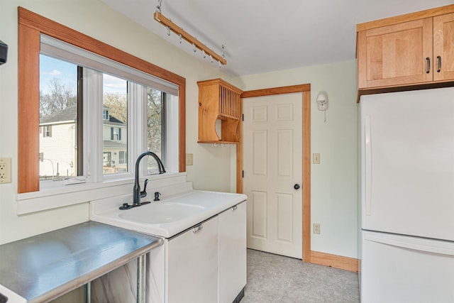 interior space with baseboards and light floors