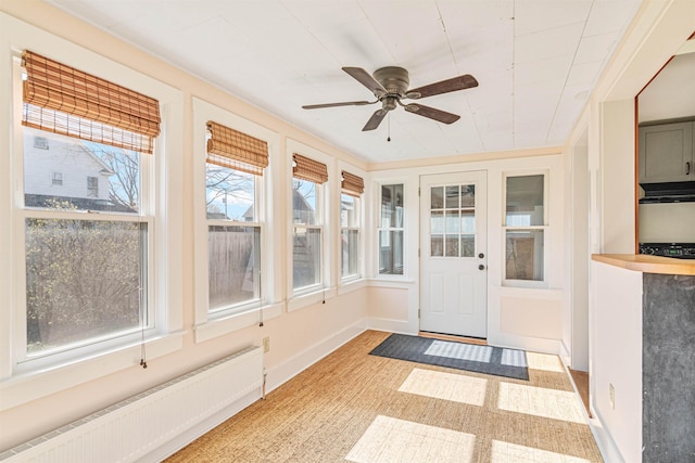 unfurnished sunroom featuring a baseboard radiator