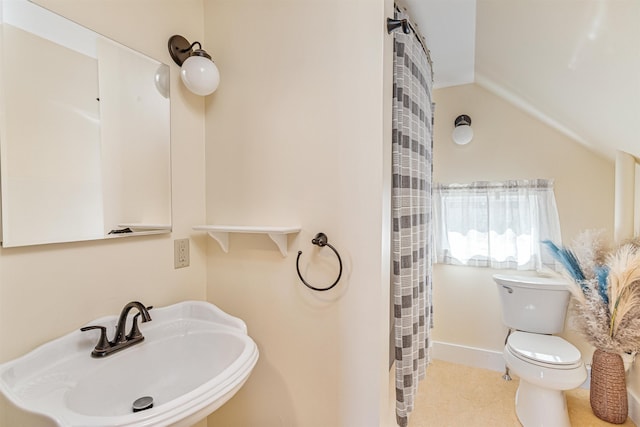 full bathroom featuring a sink, toilet, curtained shower, and lofted ceiling