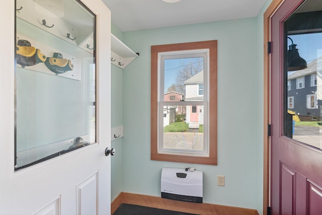 doorway to outside with baseboards