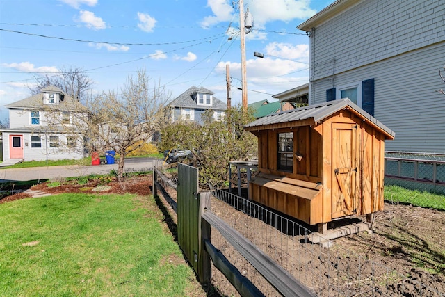 view of yard featuring exterior structure, fence, and an outdoor structure