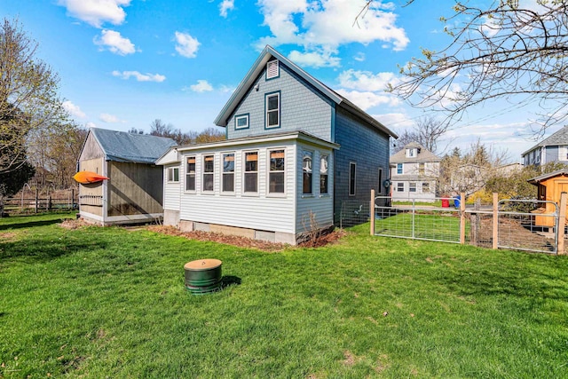 rear view of property with a yard, crawl space, and fence