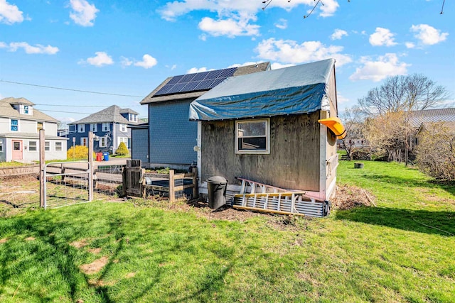 view of outbuilding featuring a residential view and solar panels