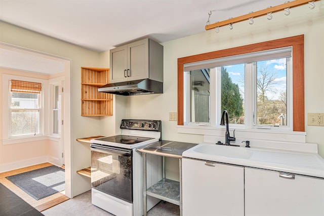 kitchen with plenty of natural light, gray cabinets, white range with electric stovetop, and under cabinet range hood