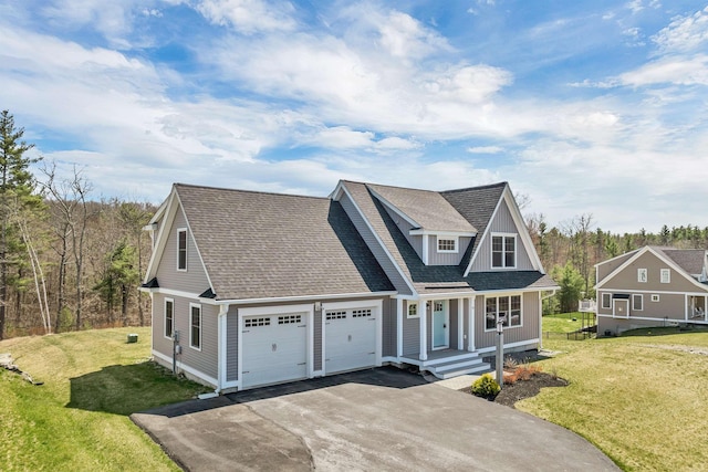view of front facade featuring a garage, covered porch, driveway, and a front lawn