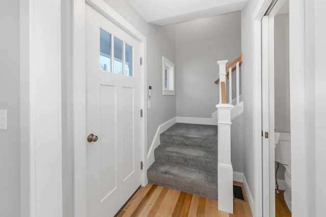 entryway featuring stairs, visible vents, and light wood finished floors