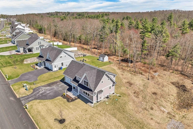 birds eye view of property with a view of trees