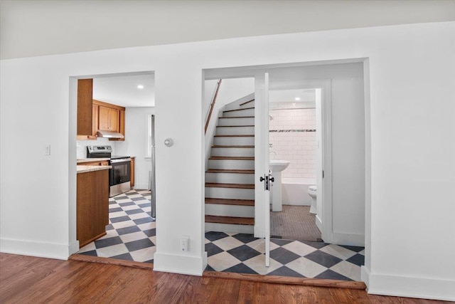 staircase featuring baseboards and tile patterned floors