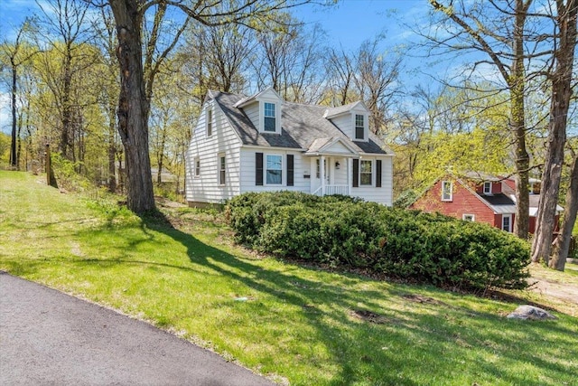 new england style home featuring a front yard