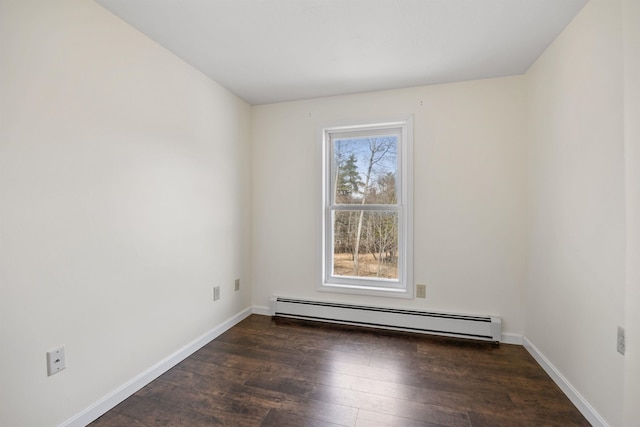empty room featuring baseboards, dark wood-type flooring, and a baseboard radiator