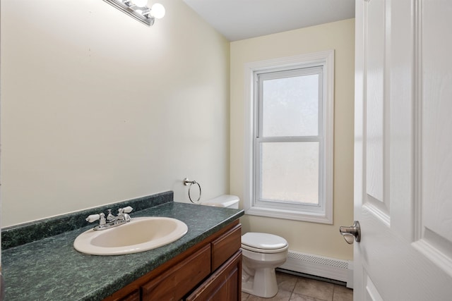 bathroom featuring vanity, tile patterned floors, a baseboard heating unit, and toilet