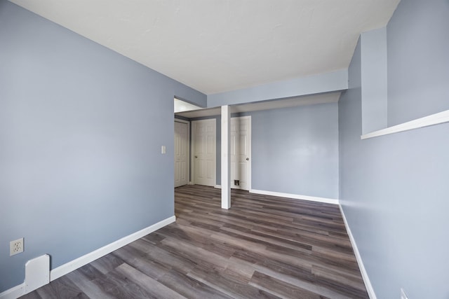 basement featuring baseboards and wood finished floors