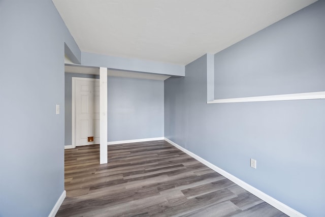 finished basement featuring baseboards and wood finished floors