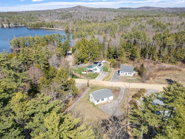 aerial view with a water view and a wooded view