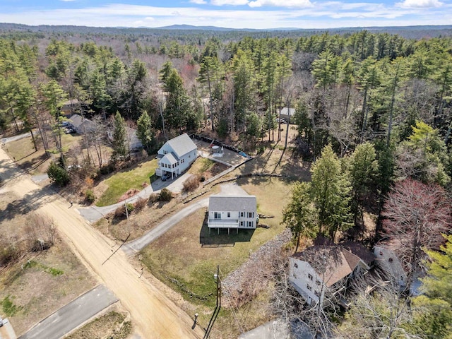 birds eye view of property with a wooded view