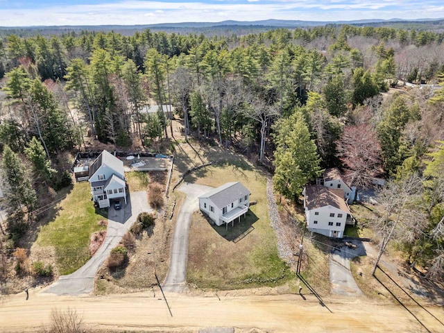 drone / aerial view featuring a forest view