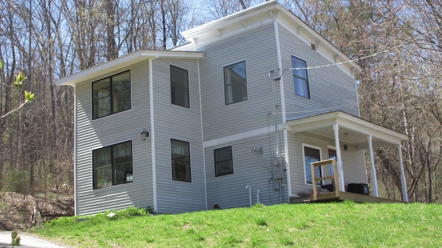 view of side of home featuring a lawn