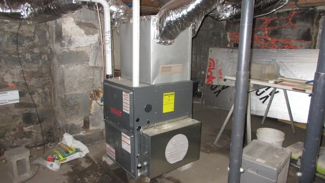 utility room featuring heating unit