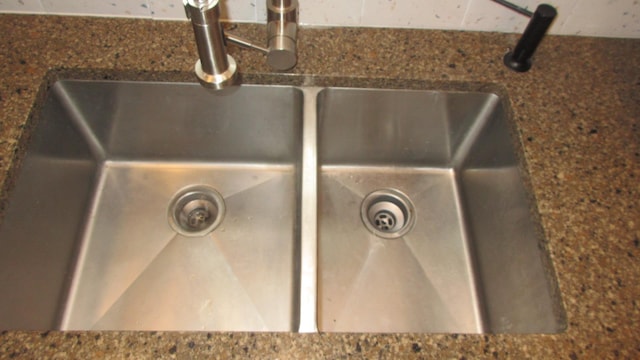 interior details with a sink and dark countertops