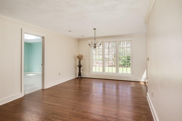 unfurnished dining area featuring crown molding, dark wood-style flooring, baseboards, and a notable chandelier