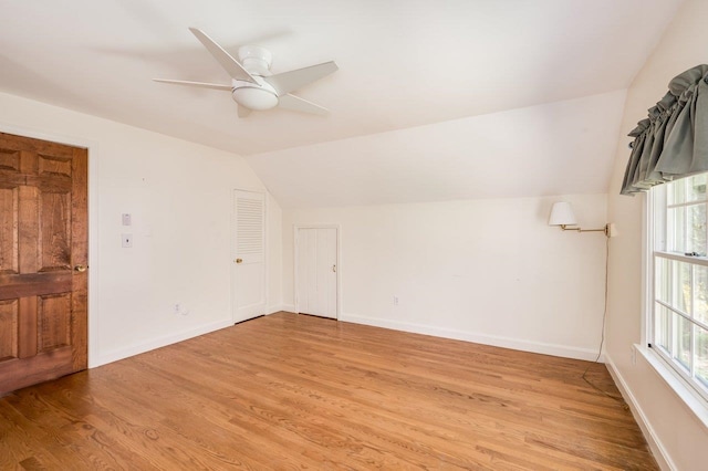 additional living space with a wealth of natural light, light wood-type flooring, and lofted ceiling