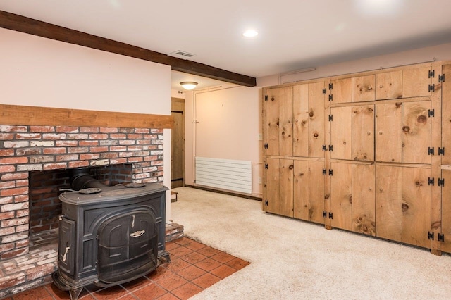 interior space with recessed lighting, visible vents, and a wood stove