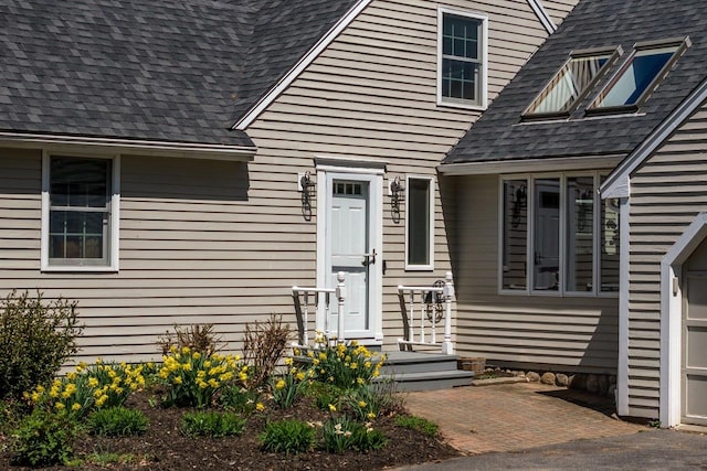 entrance to property with a shingled roof